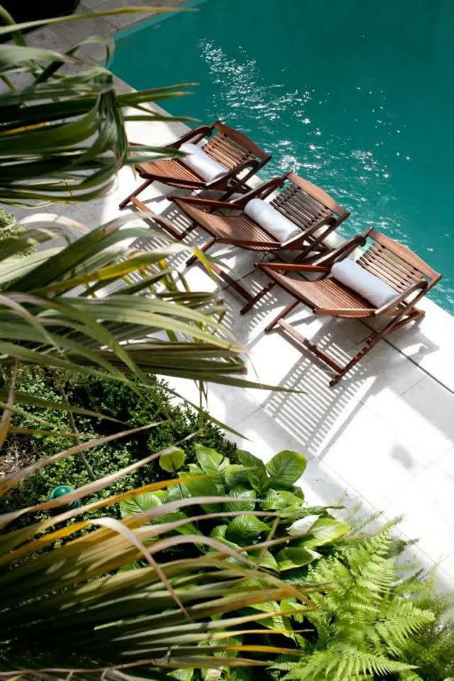 Lounge chairs beside the atrium pool