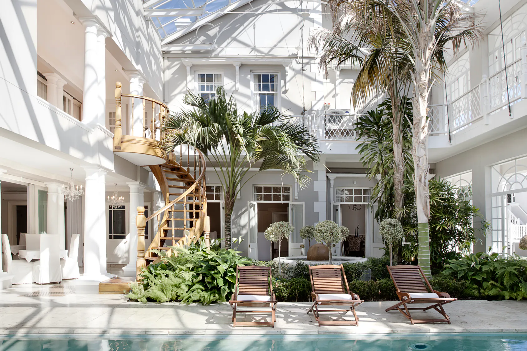 Glass atrium, pool, and spiral staircase