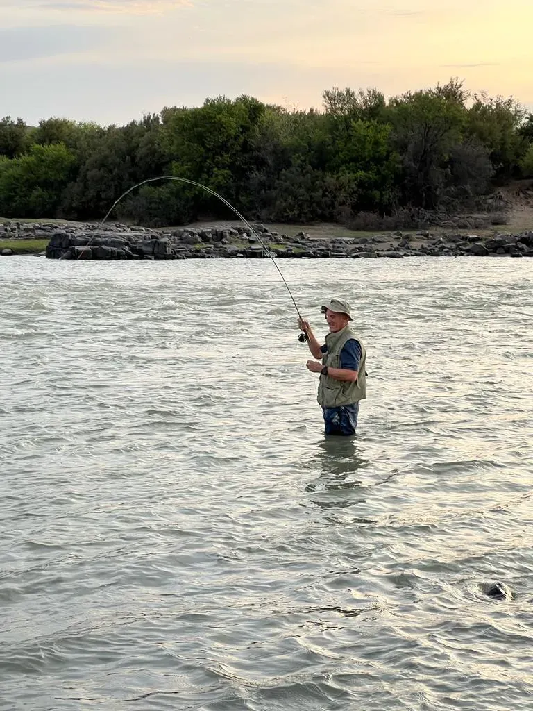 An angler fly fishing from the Orange River
