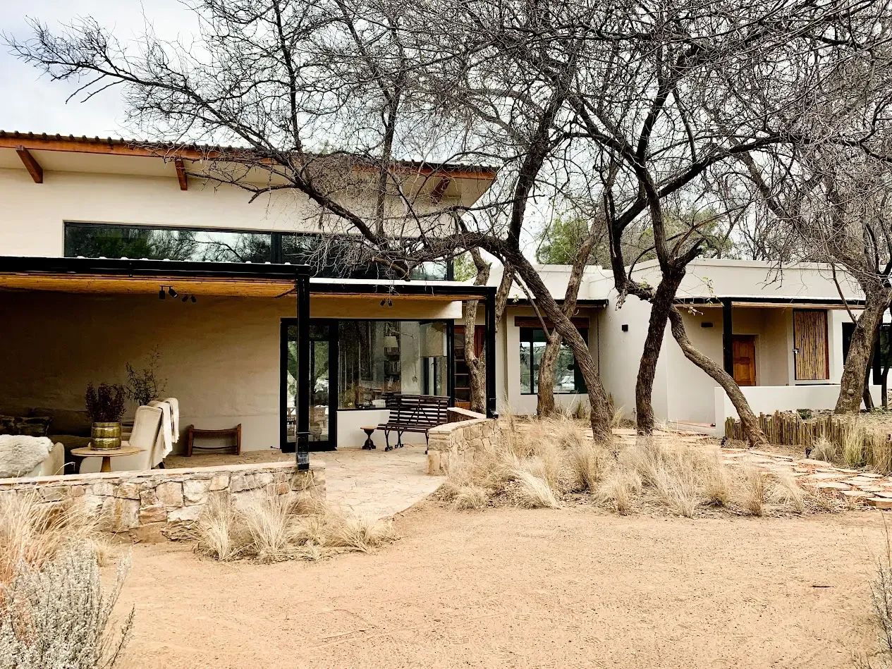 The River House exterior beneath mature trees