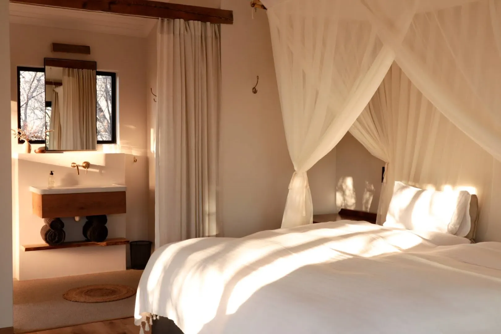 A bedroom with mosquito-netted bed at The River House
