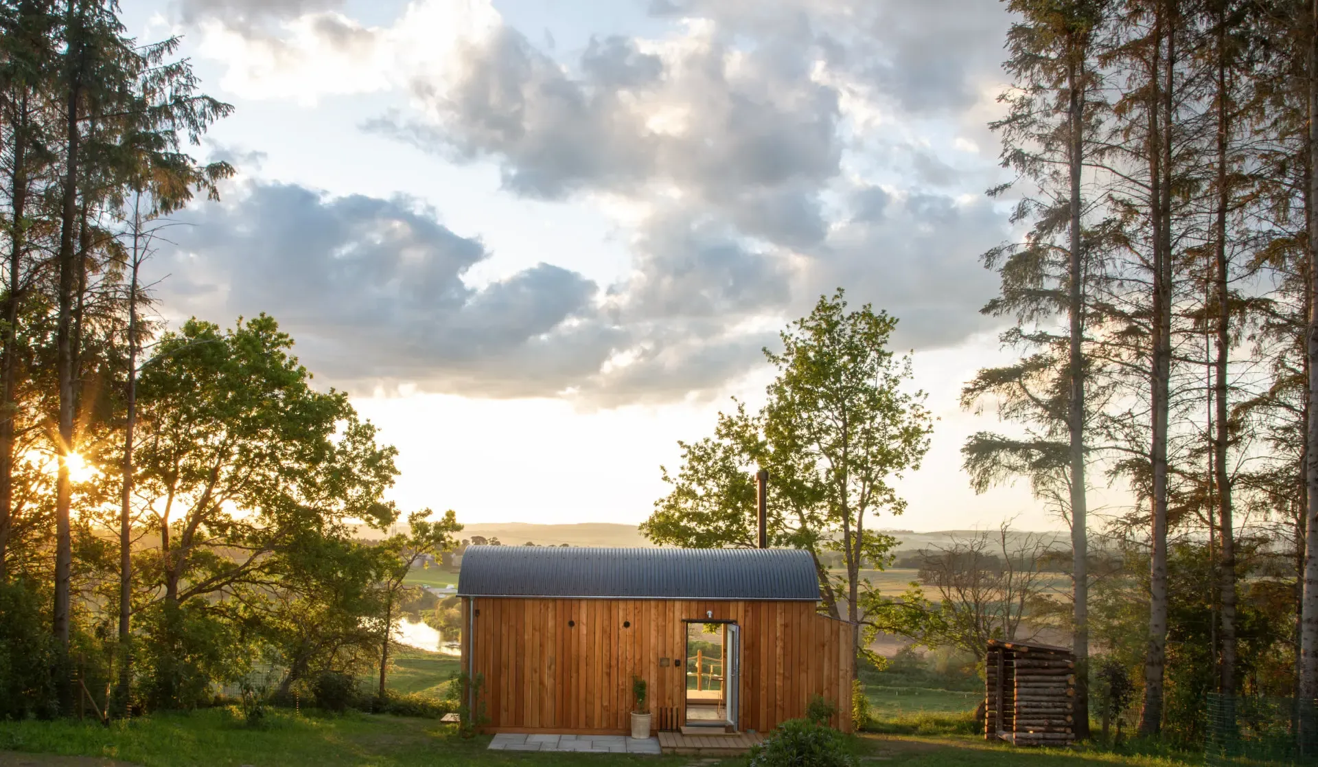 A timber cabin overlooking the Perthshire countryside at sunset