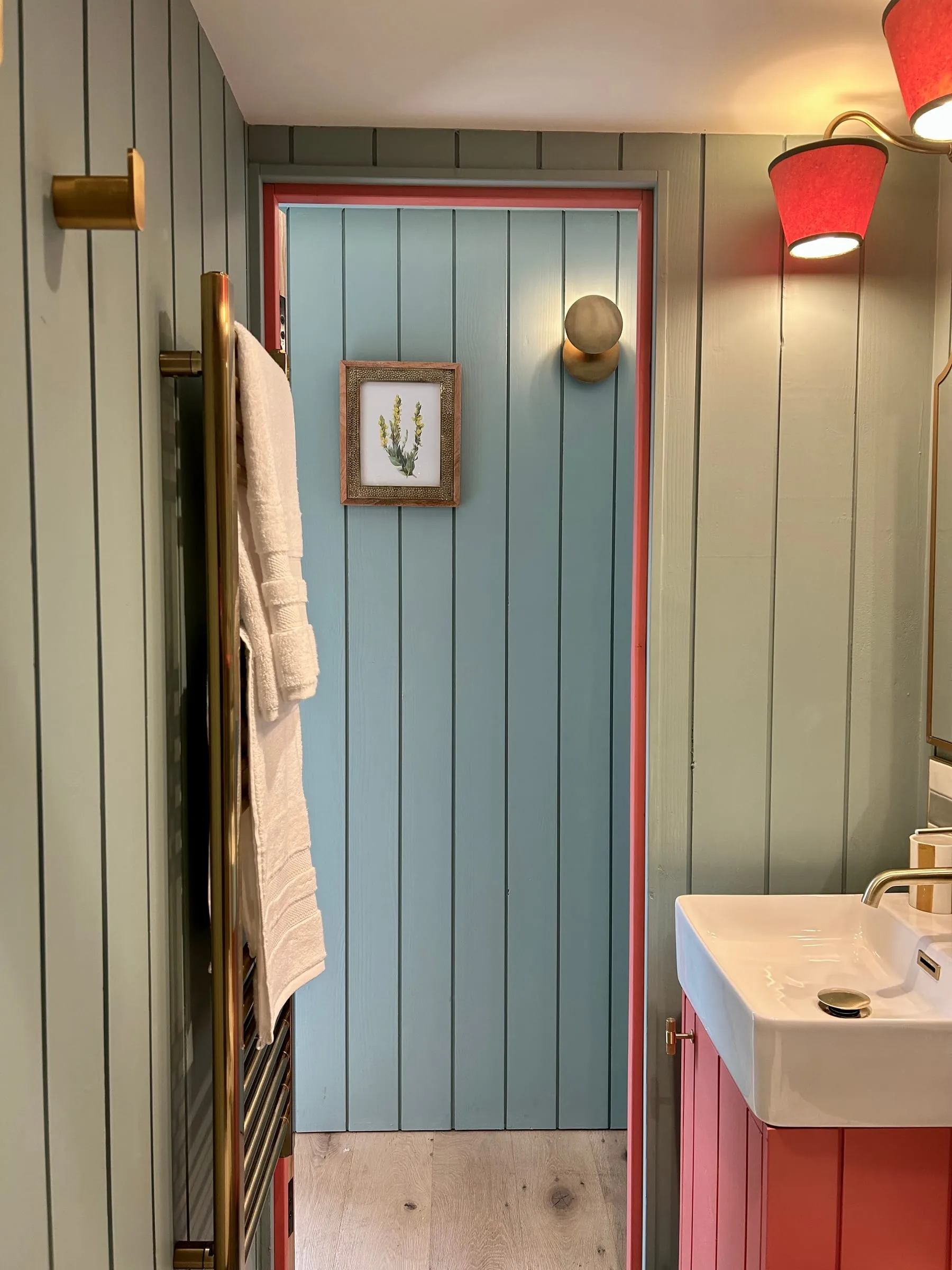 Milkwood's bathroom doorway and pink vanity