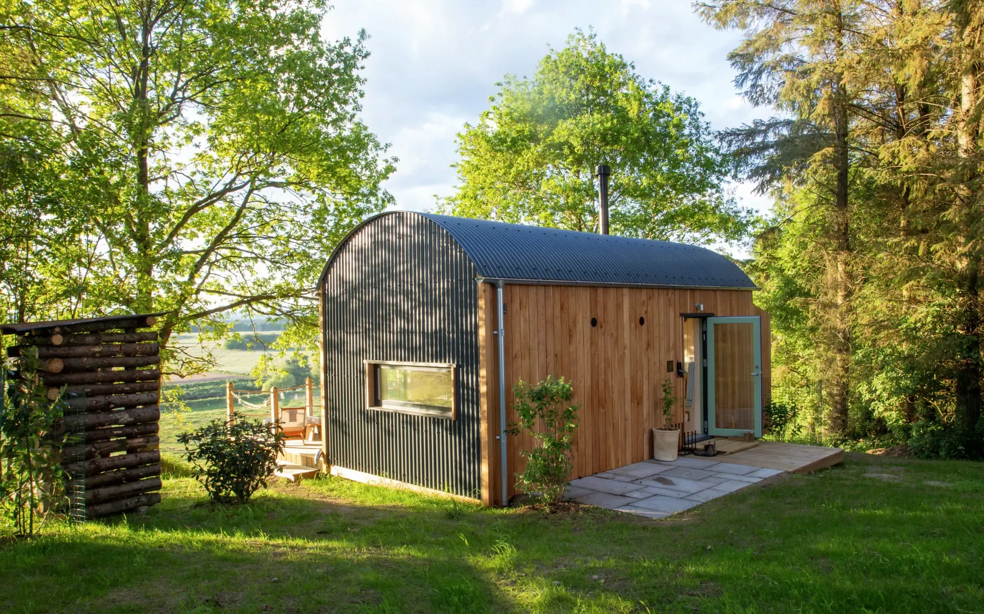 Fairlight cabin in a sunlit woodland clearing