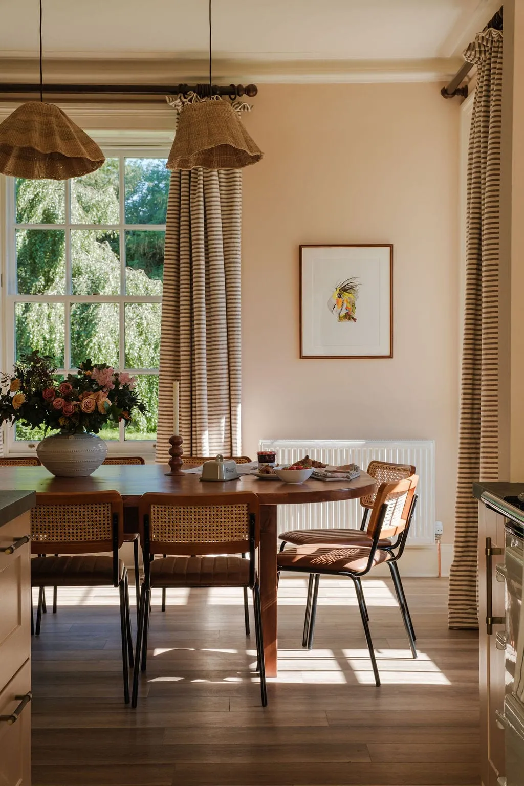 The dining table at Links Farmhouse beneath woven pendants