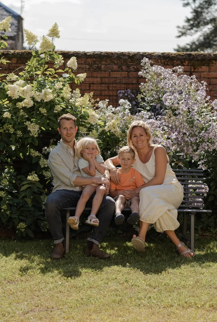 Wheeze and Hendy with their children in the garden