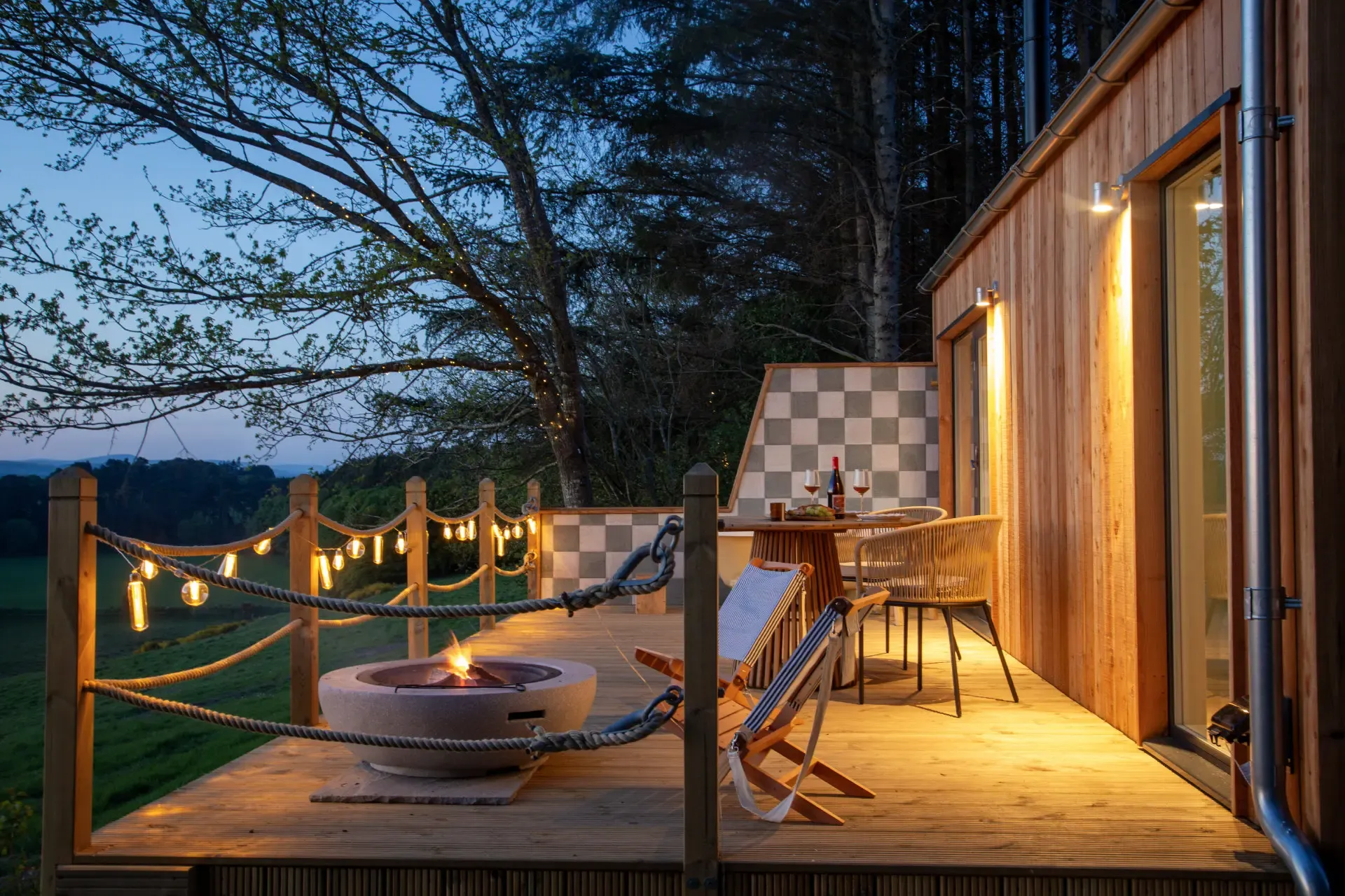 Milkwood's private deck lit for an evening outdoors