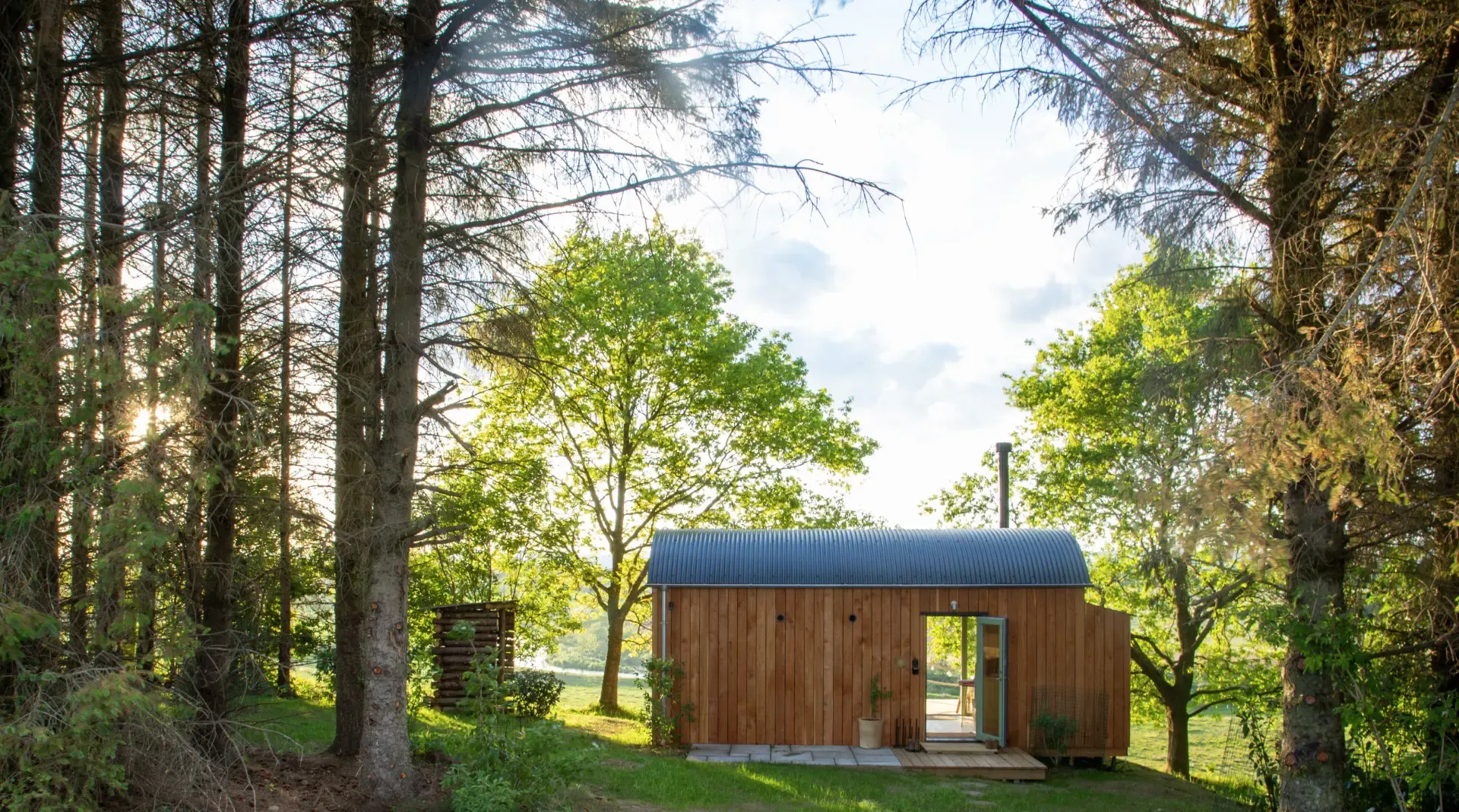 A Lawton Links cabin among sunlit trees