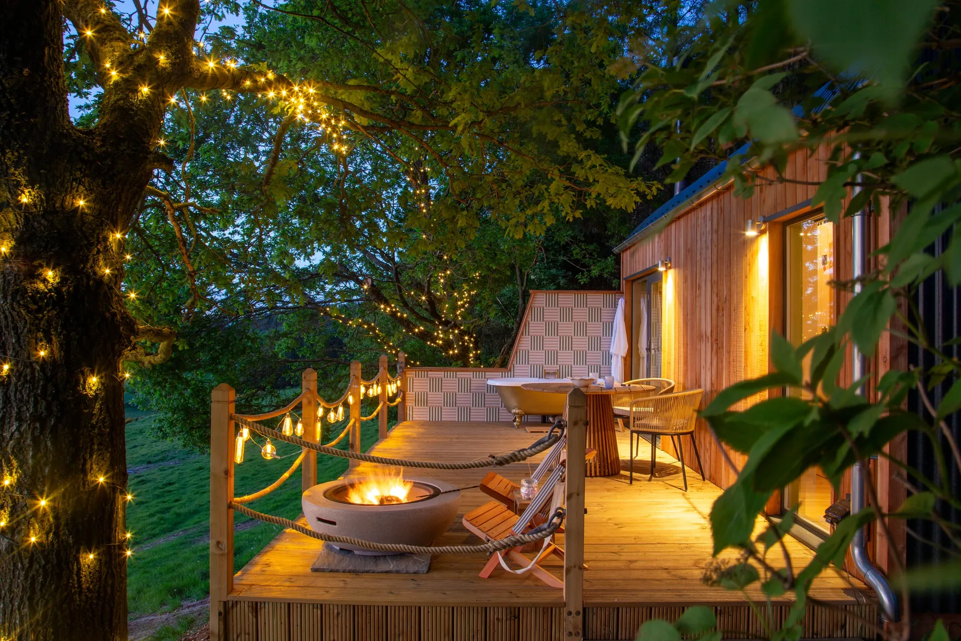 Fairlight's deck, outdoor bath and fire pit at dusk