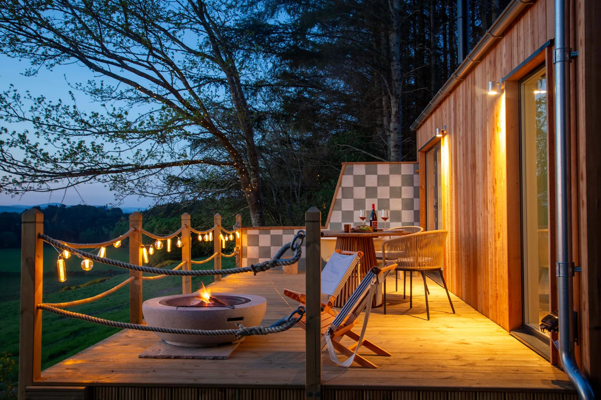 Milkwood's deck and fire pit at dusk