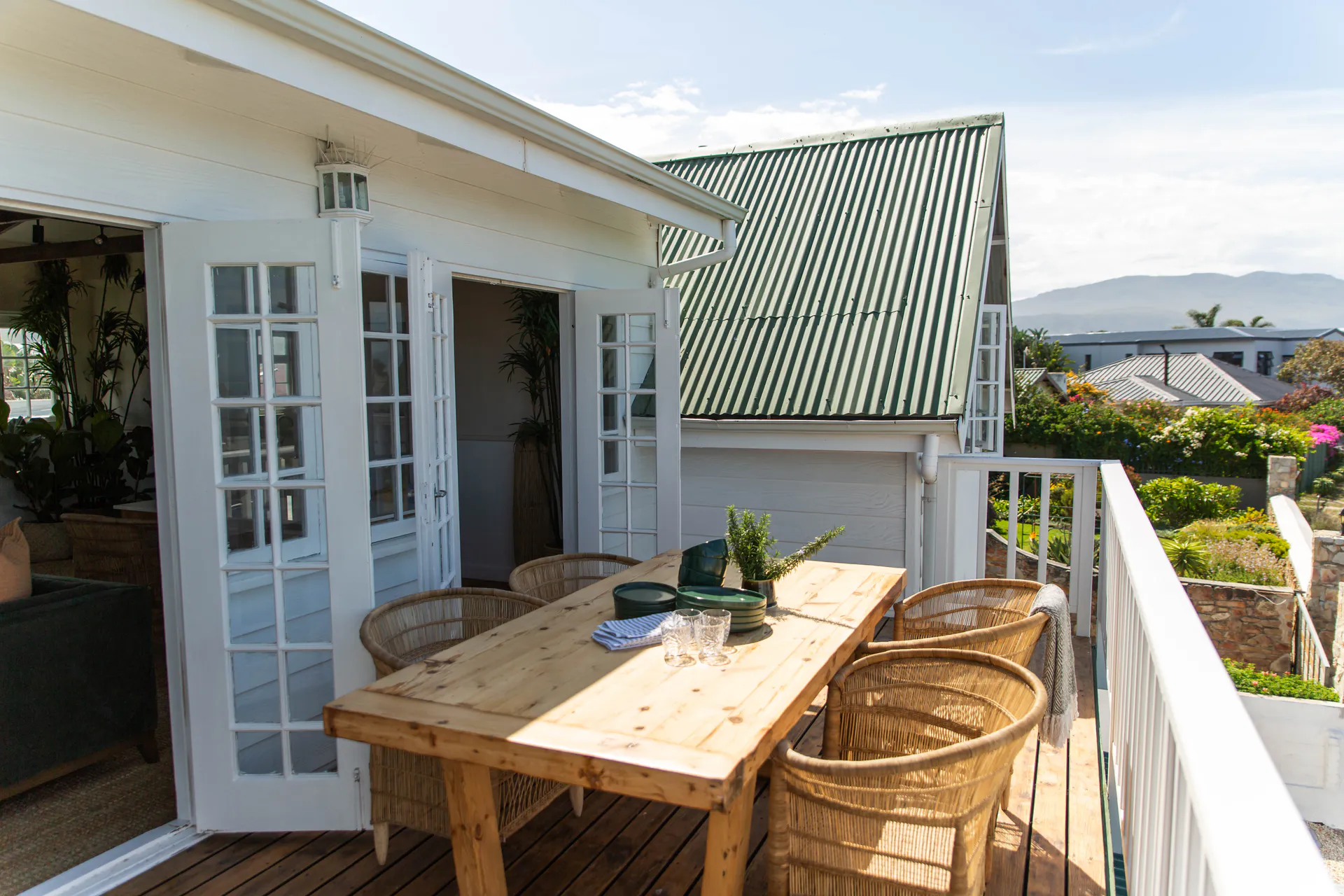 Balcony dining beside the open Sea Facing Apartment doors