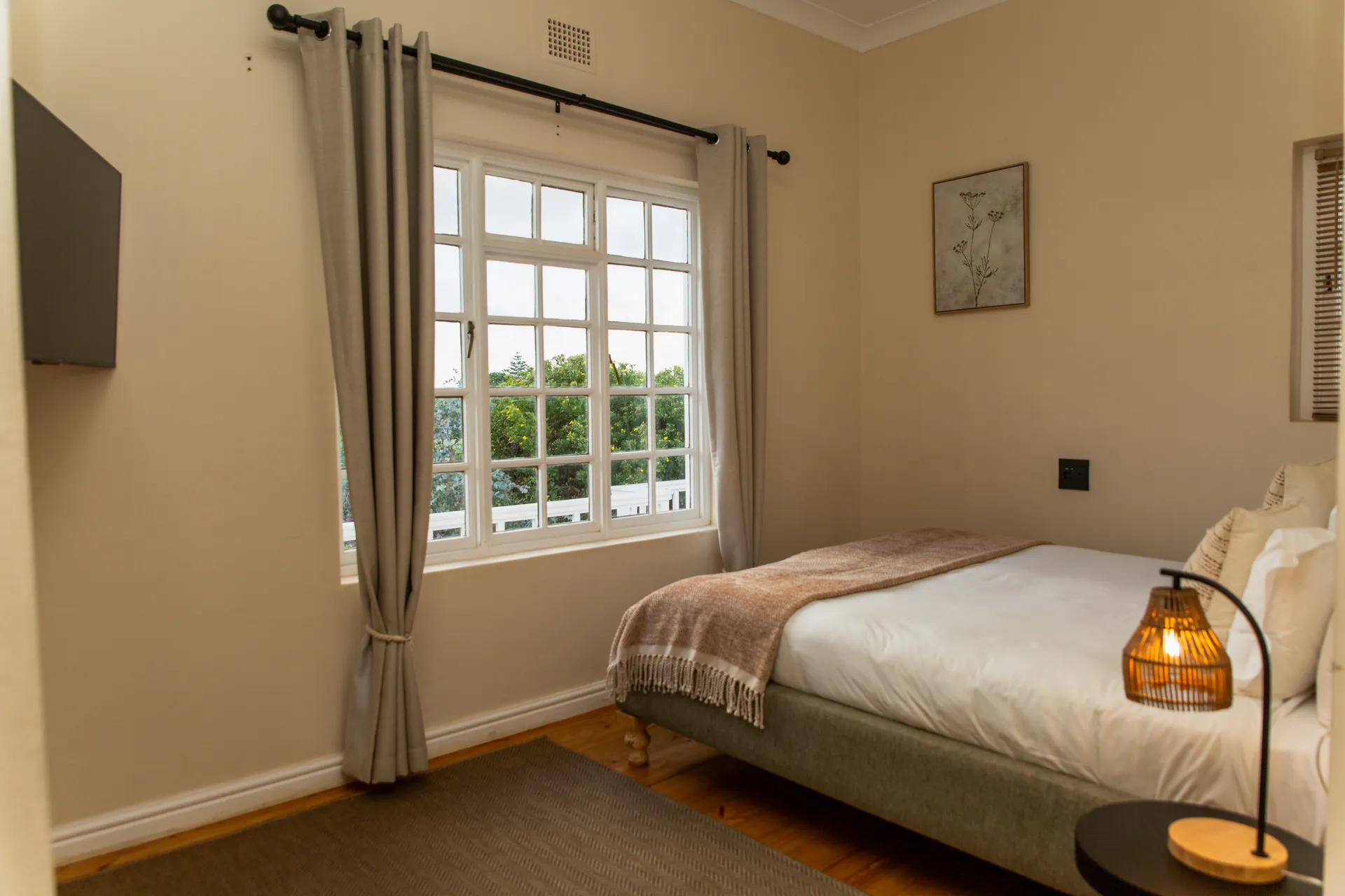 Ground Floor Apartment bedroom with TV and garden window