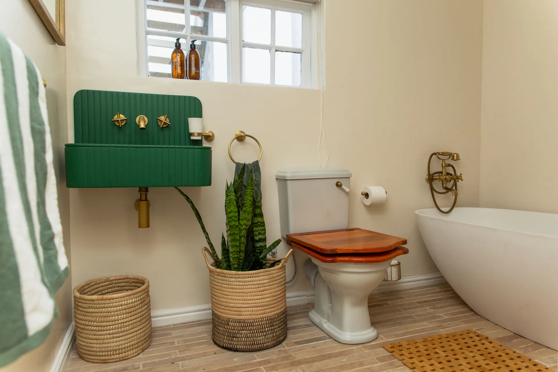 Family Room bathroom with green basin and freestanding bath