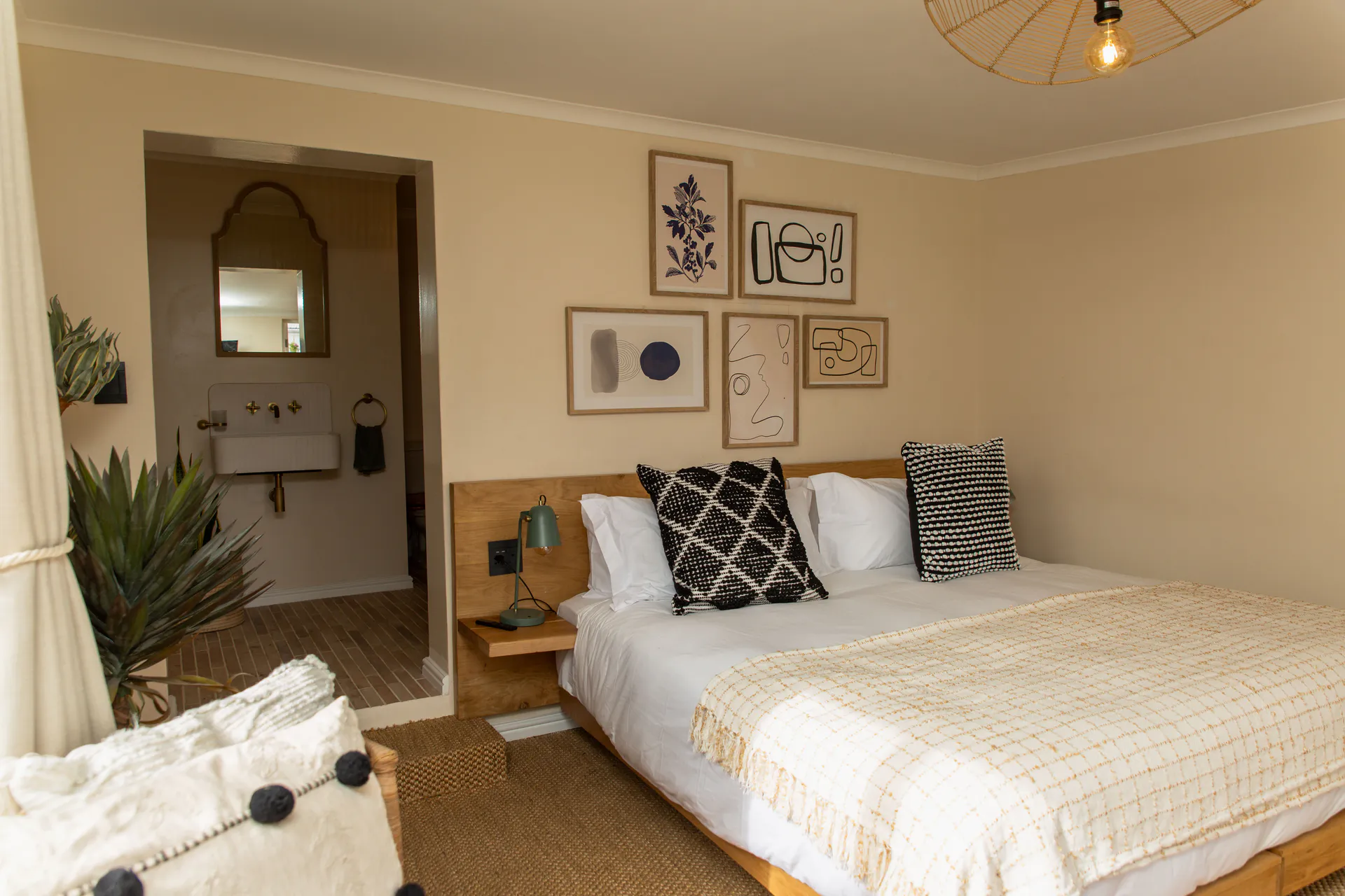 Standard Garden Room bed with a view through to the en-suite