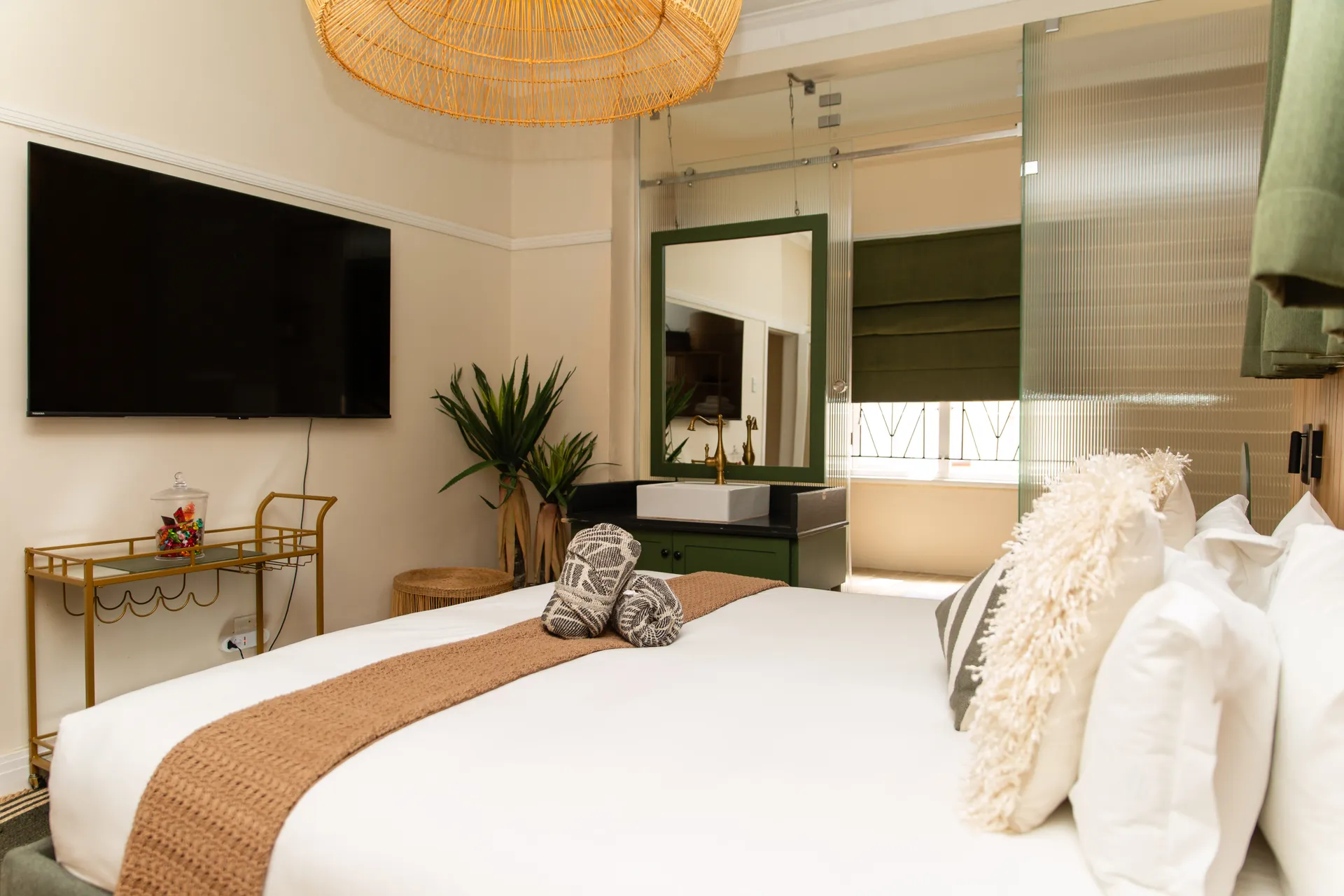 Bedroom looking toward a glass-screened en-suite