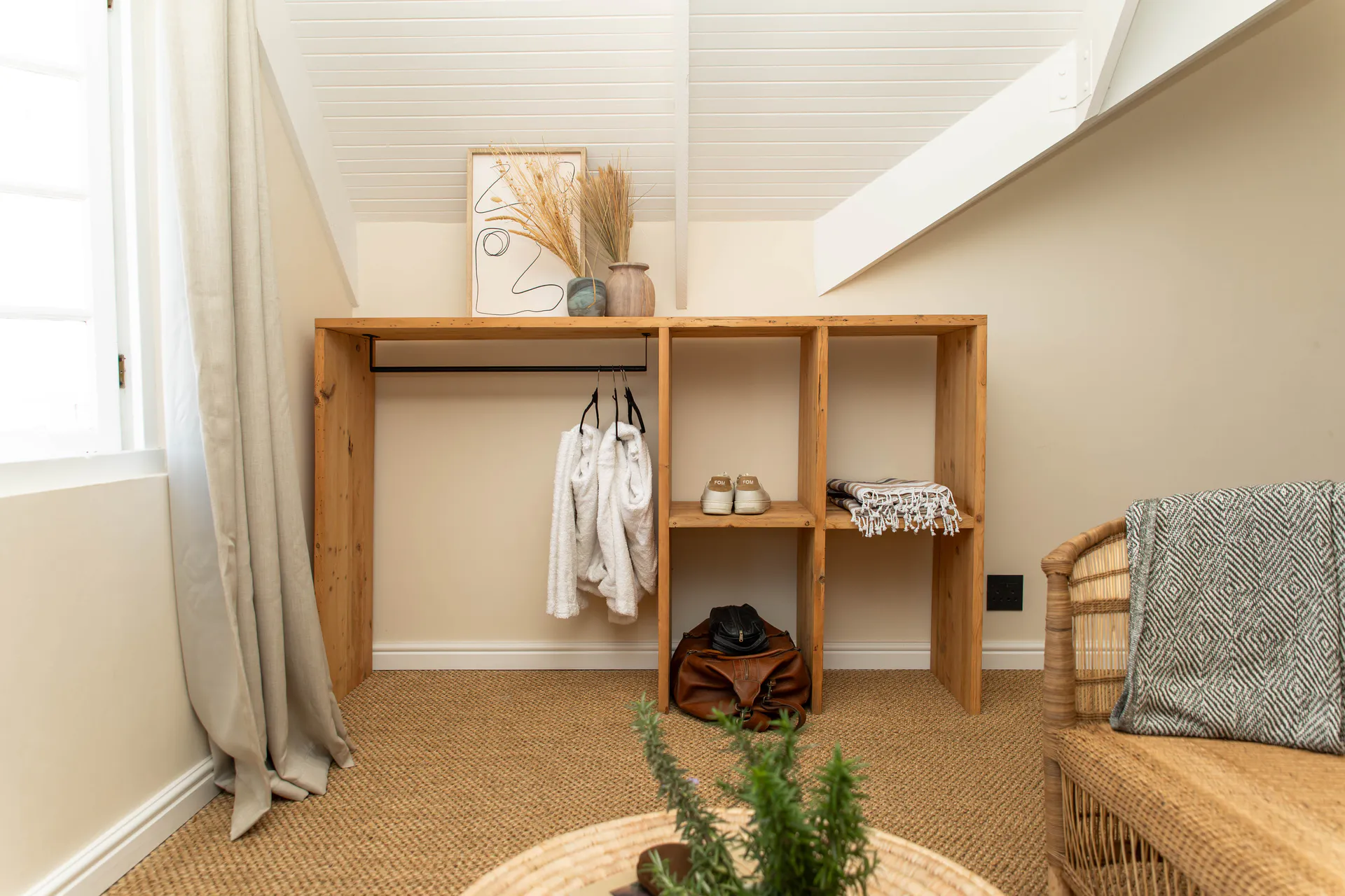 Open wardrobe under the eaves in the Sea Facing Apartment