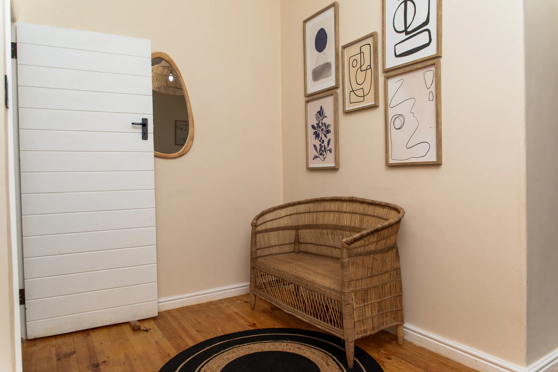 Wicker bench and gallery wall in the Ground Floor Apartment