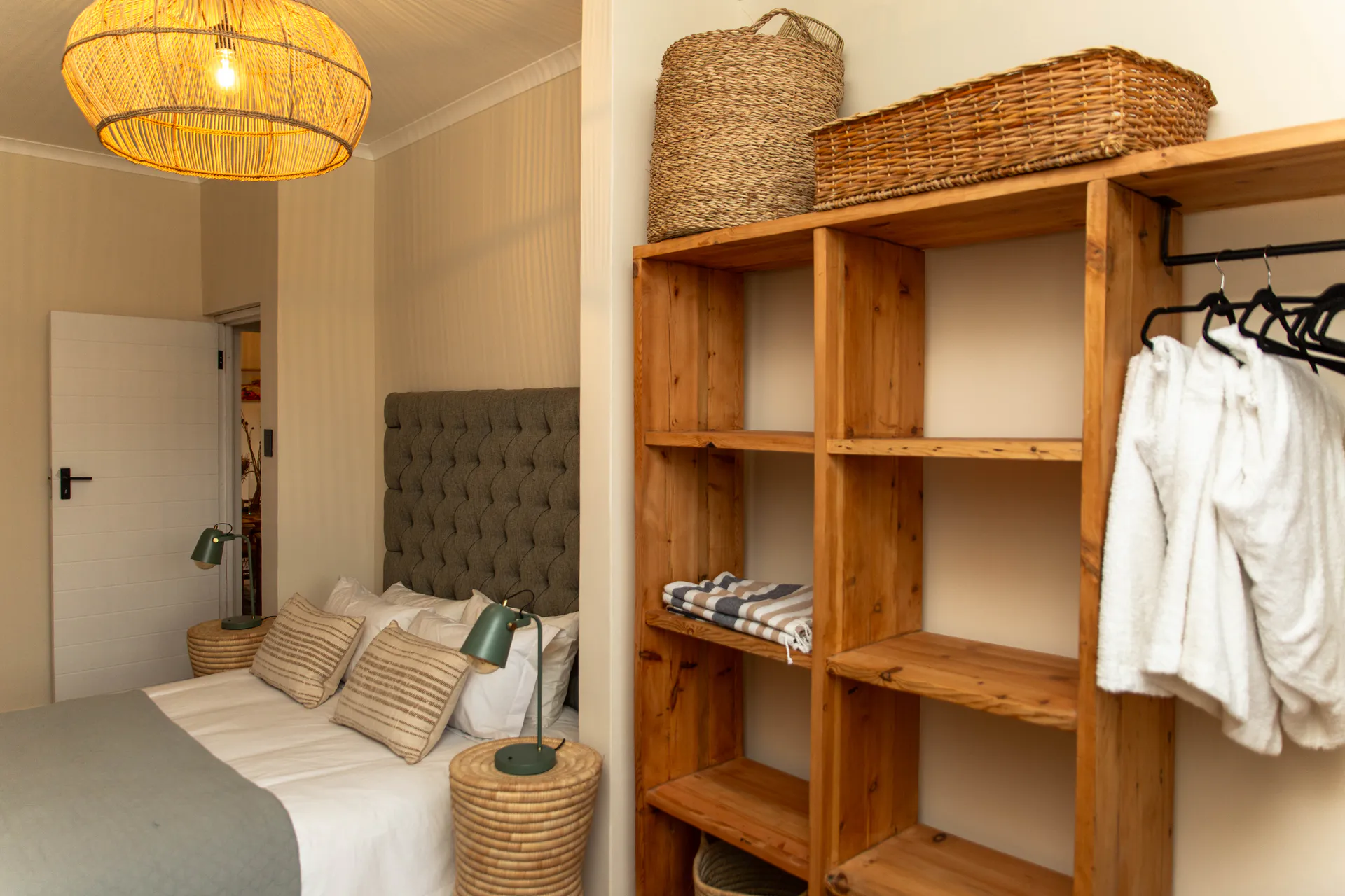 Ground Floor Apartment bedroom with tufted headboard and open wardrobe