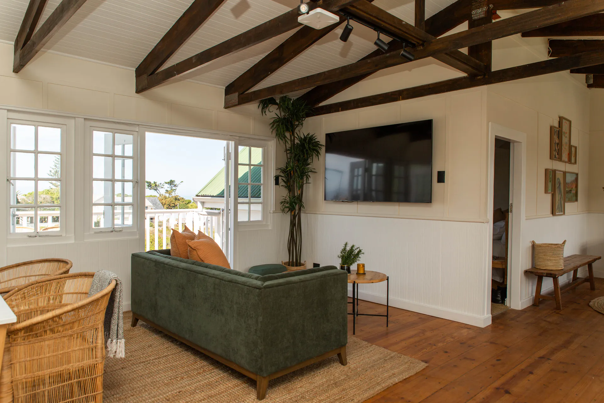 Sea Facing Apartment living room with vaulted beams and balcony doors