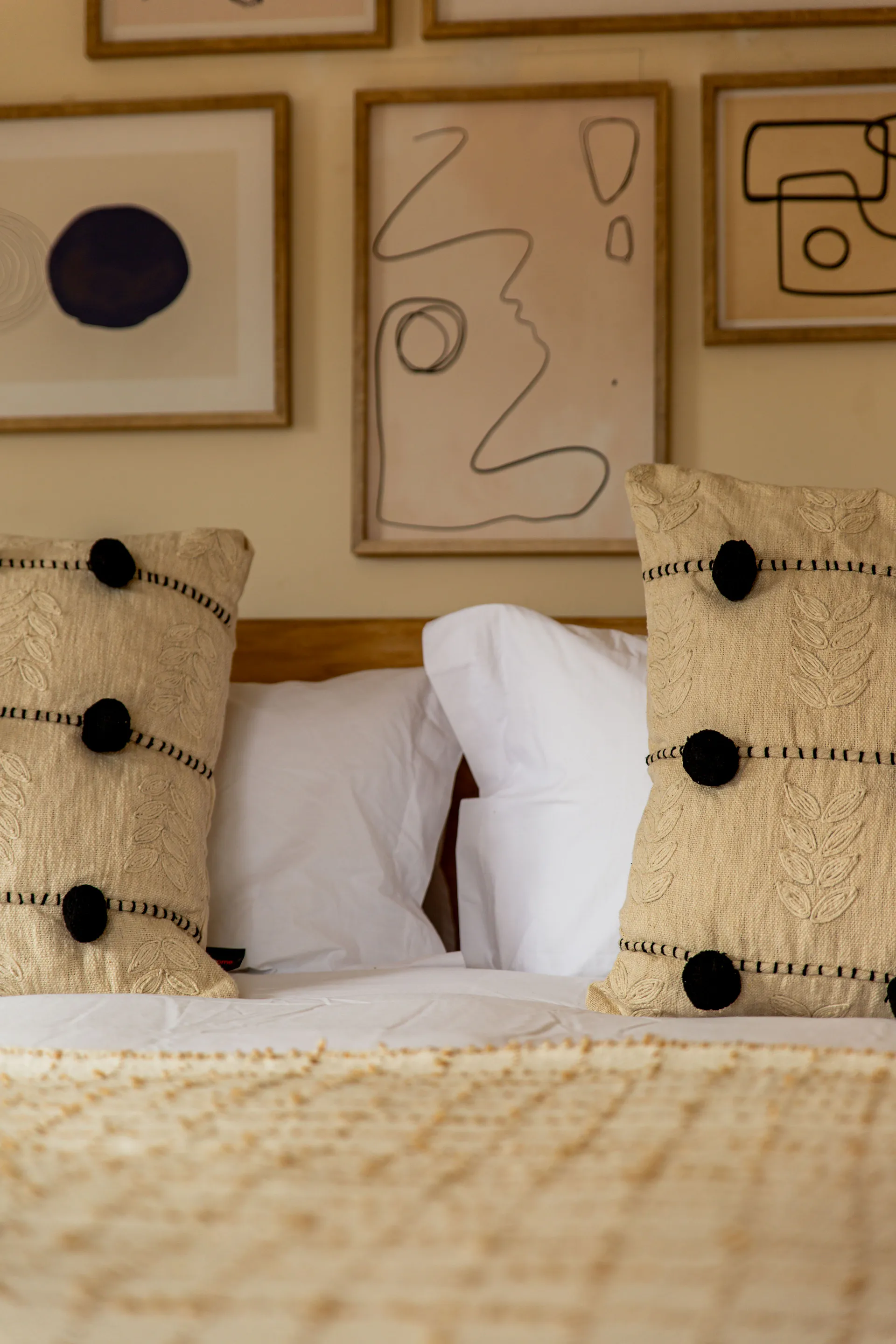 Standard Garden Room pillows and framed art above the bed