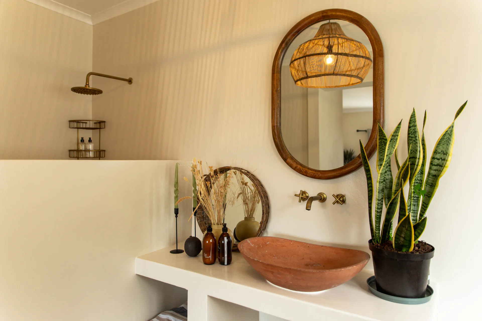 Terracotta basin and wooden mirror in a Ground Floor Apartment bathroom