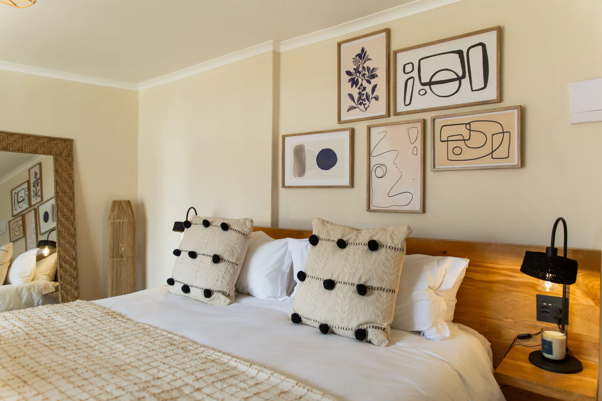 Family Room pillows, gallery wall and rattan mirror