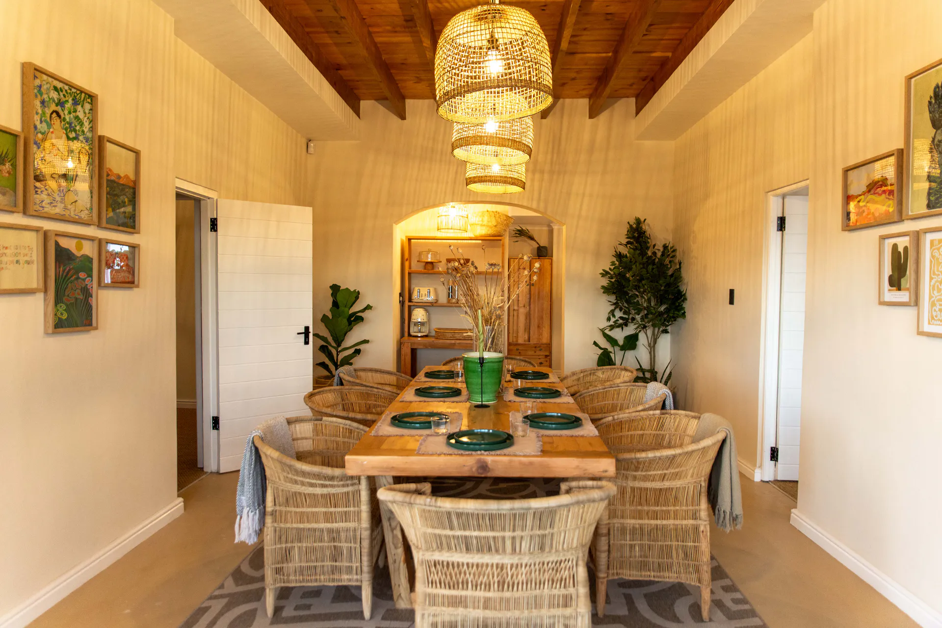Ground Floor Apartment dining table with gallery walls and rattan chairs
