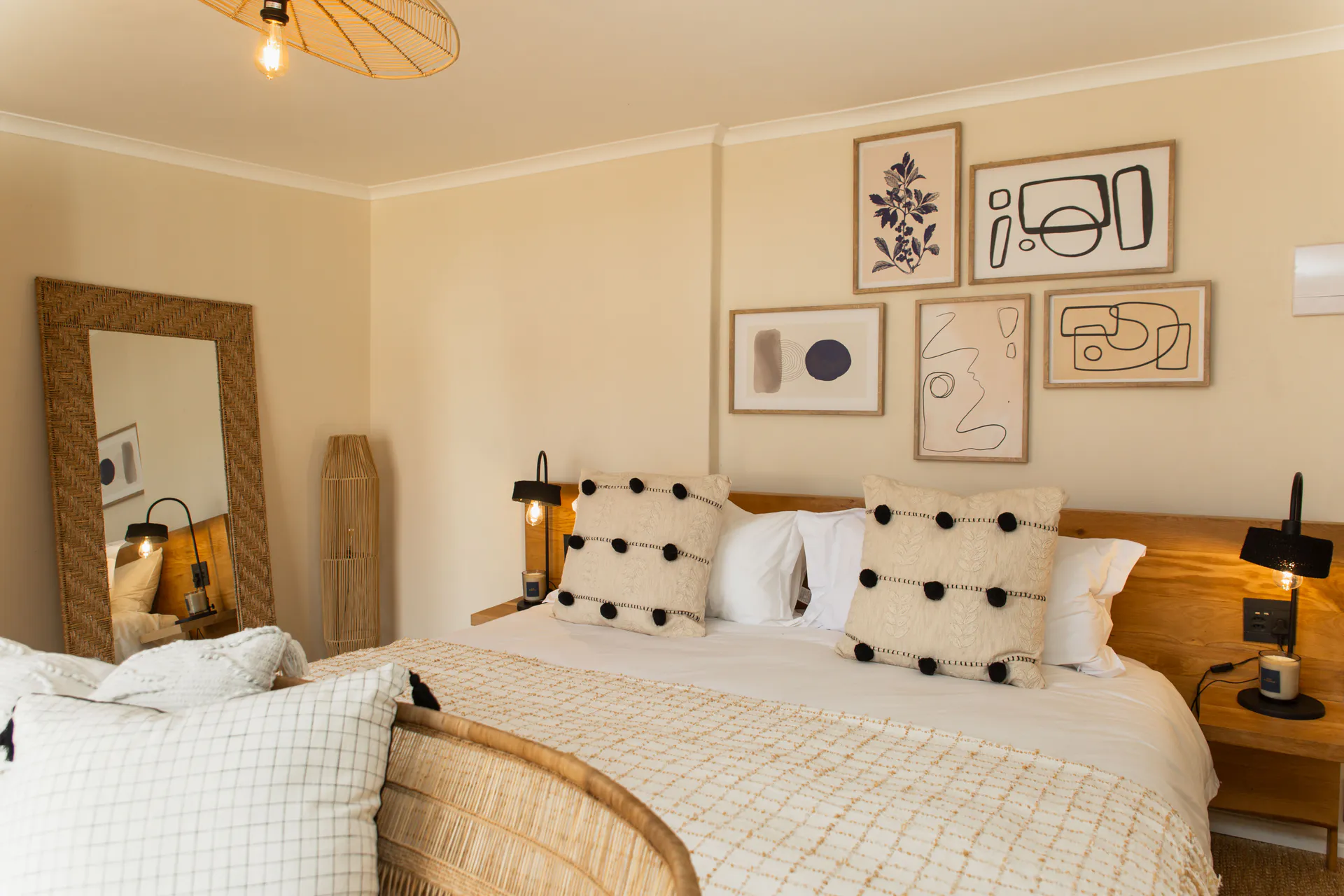 Family Room bed, gallery wall and rattan mirror