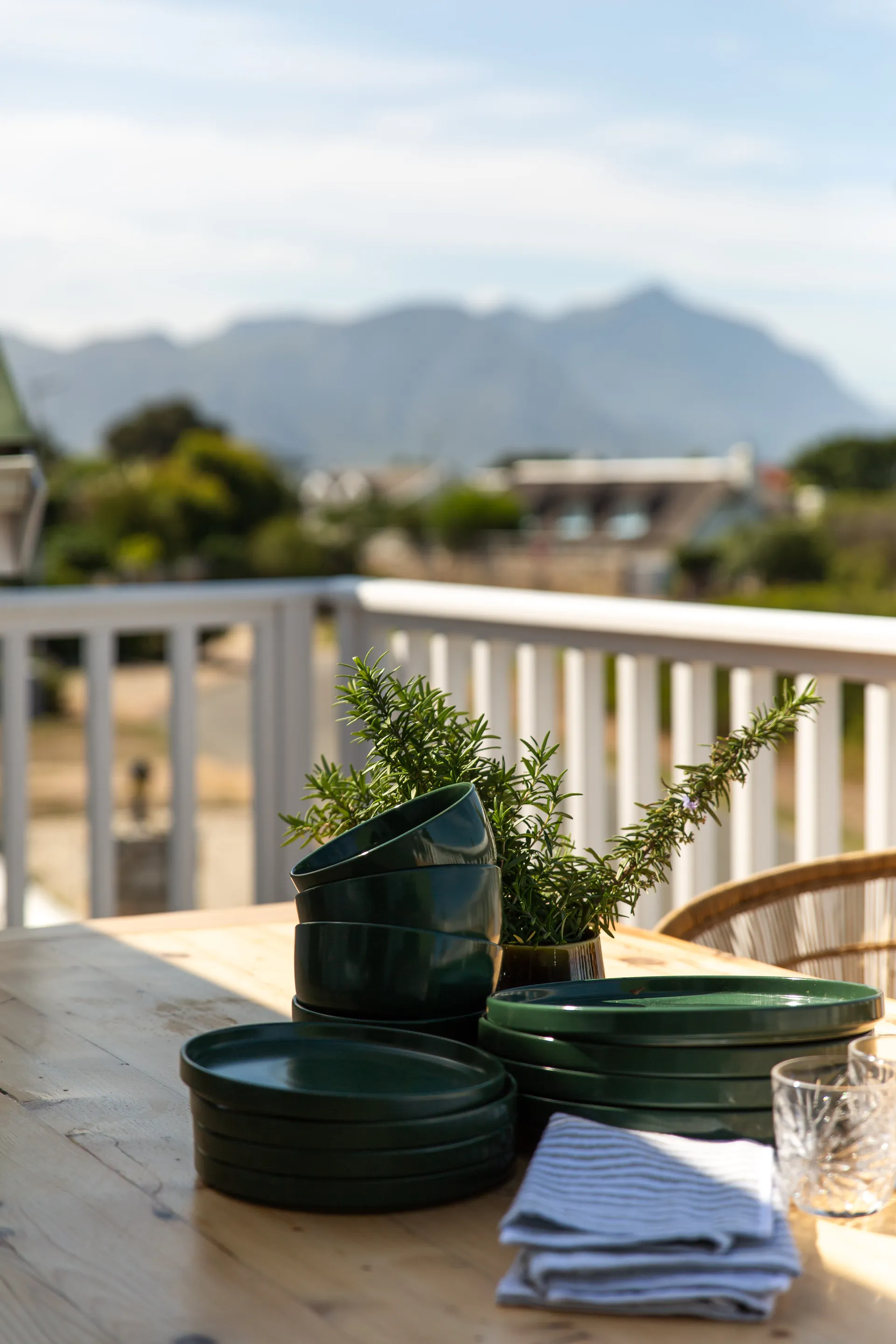 Outdoor dining table on a balcony overlooking Hermanus
