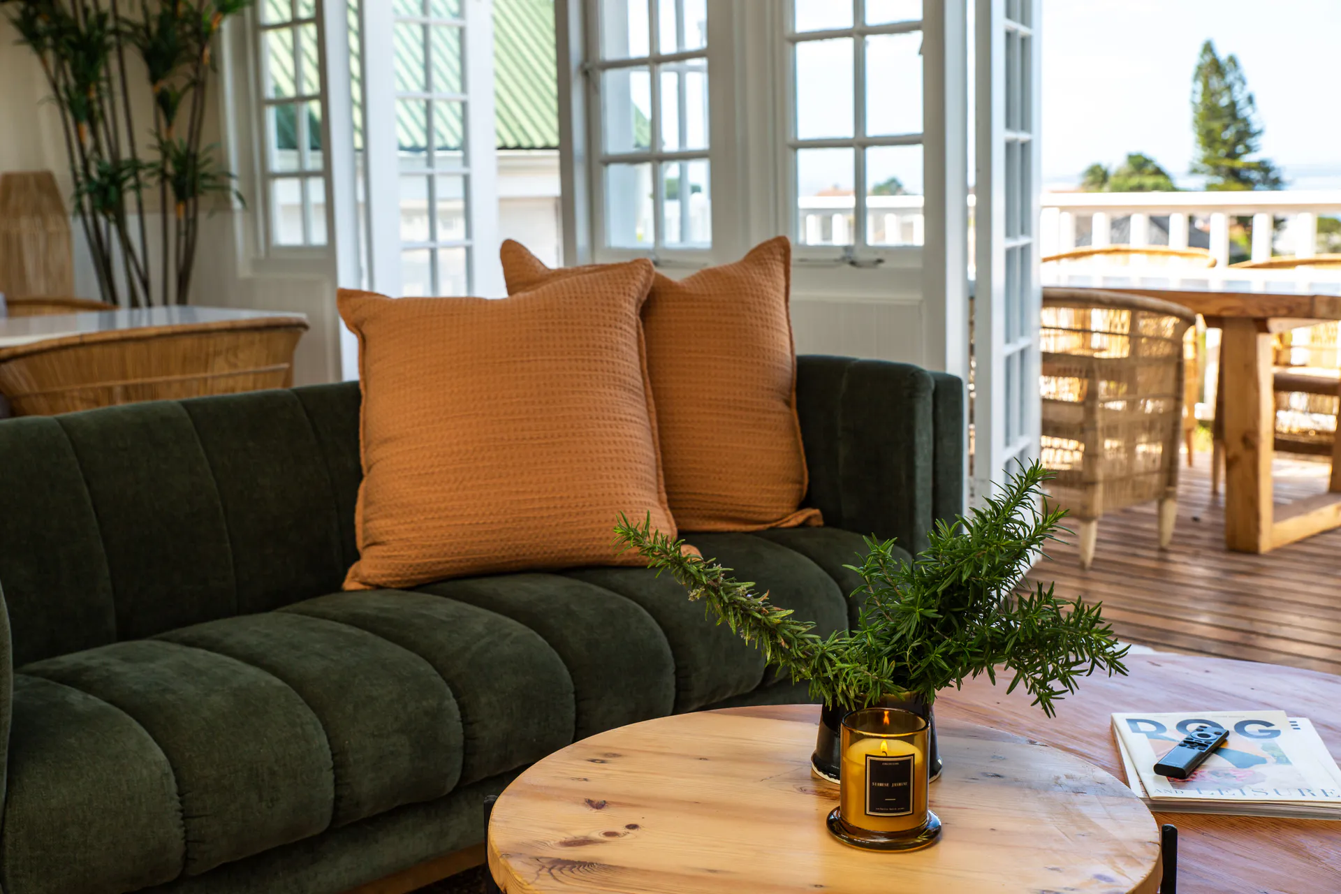 Green sofa looking out to the Sea Facing Apartment balcony