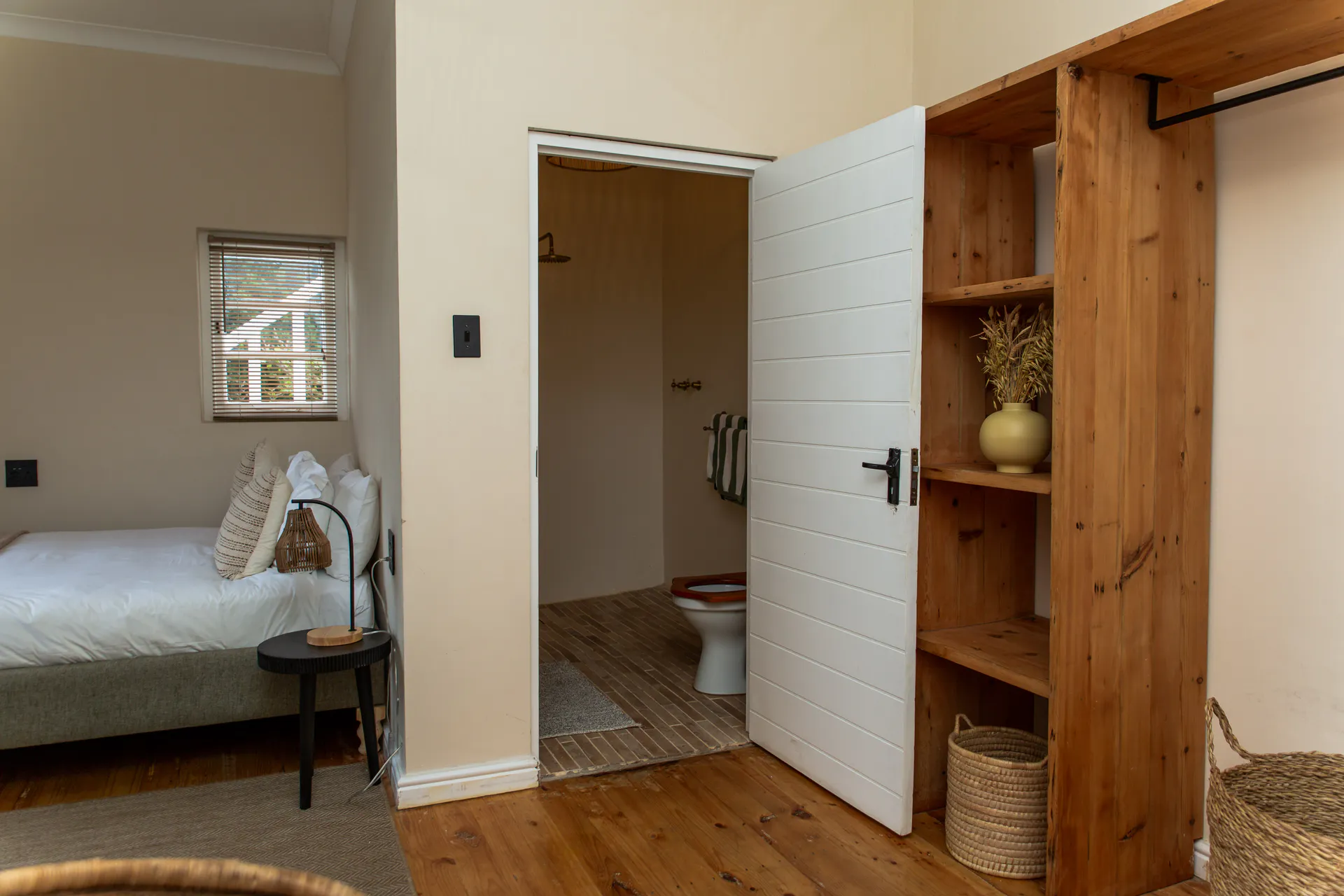 Open wardrobe and en-suite in a Ground Floor Apartment bedroom