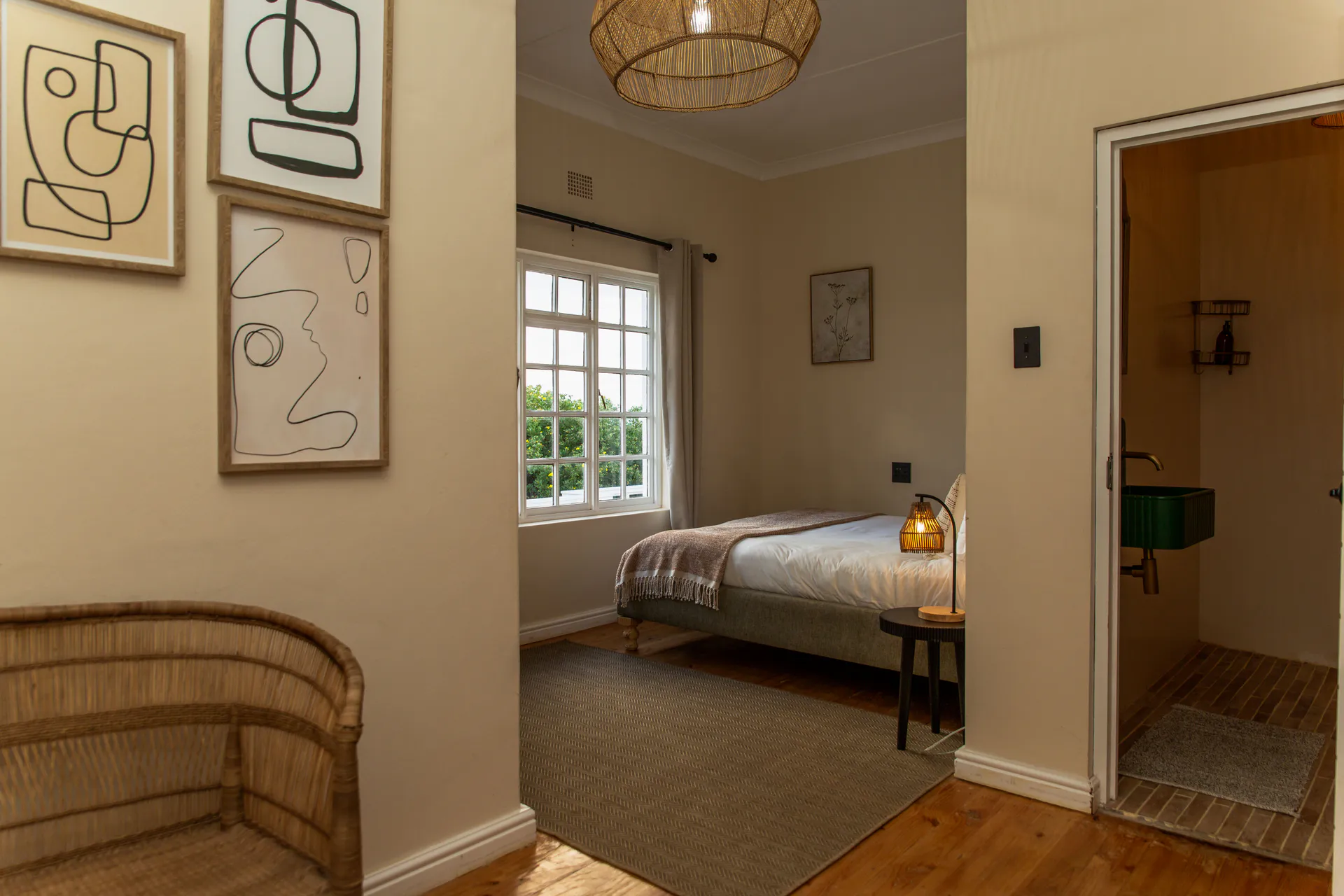Ground Floor Apartment bedroom with a glimpse of the green-basin bathroom