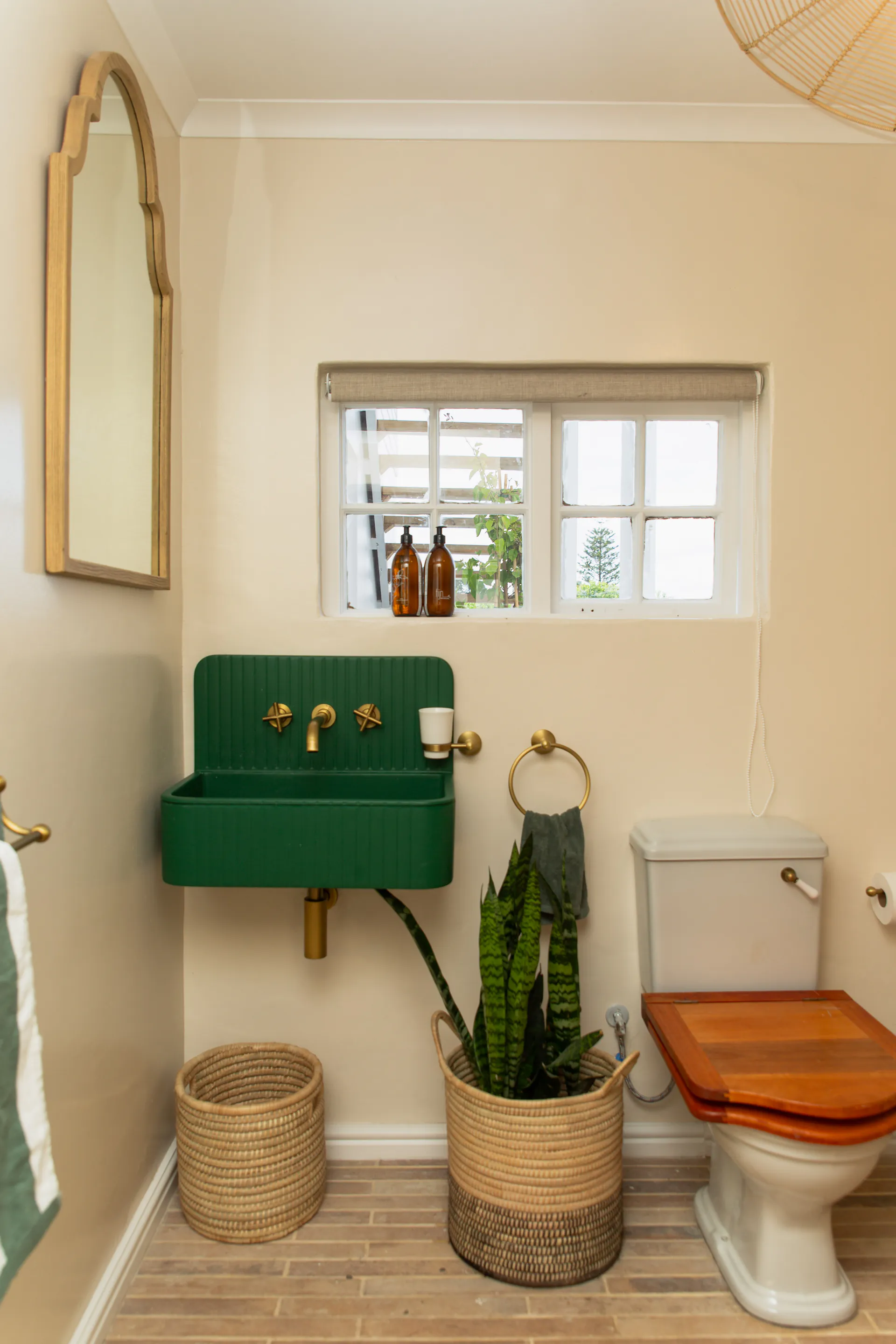 Forest-green basin and brass taps in the Family Room bathroom