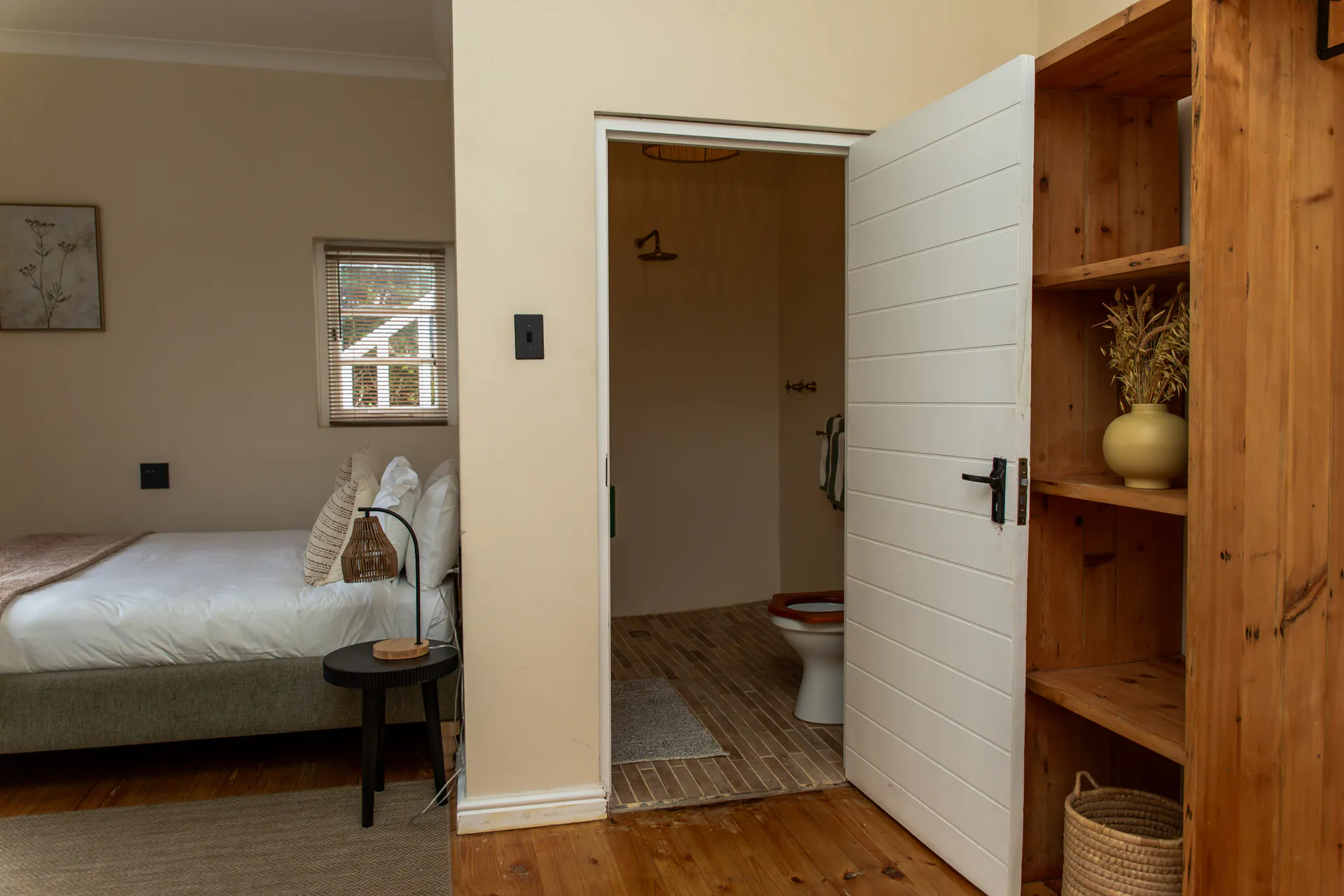 Ground Floor Apartment bedroom, en-suite and wooden shelves