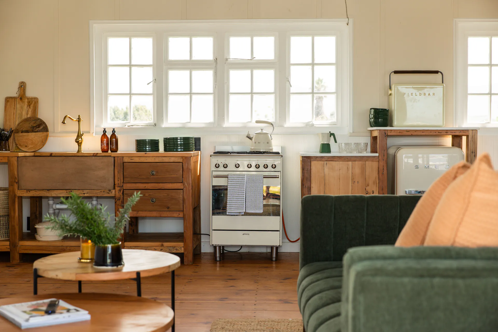 Sea Facing Apartment kitchen with farmhouse sink and green sofa