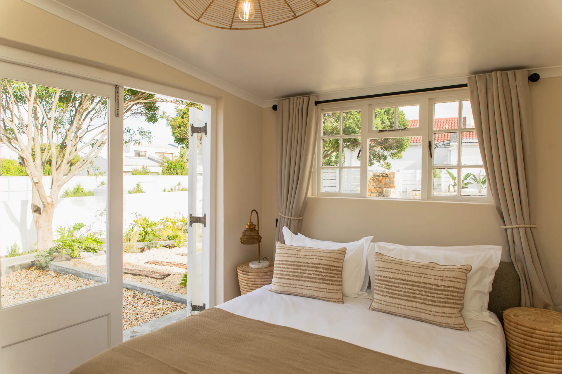 Family Room bed beside open garden doors