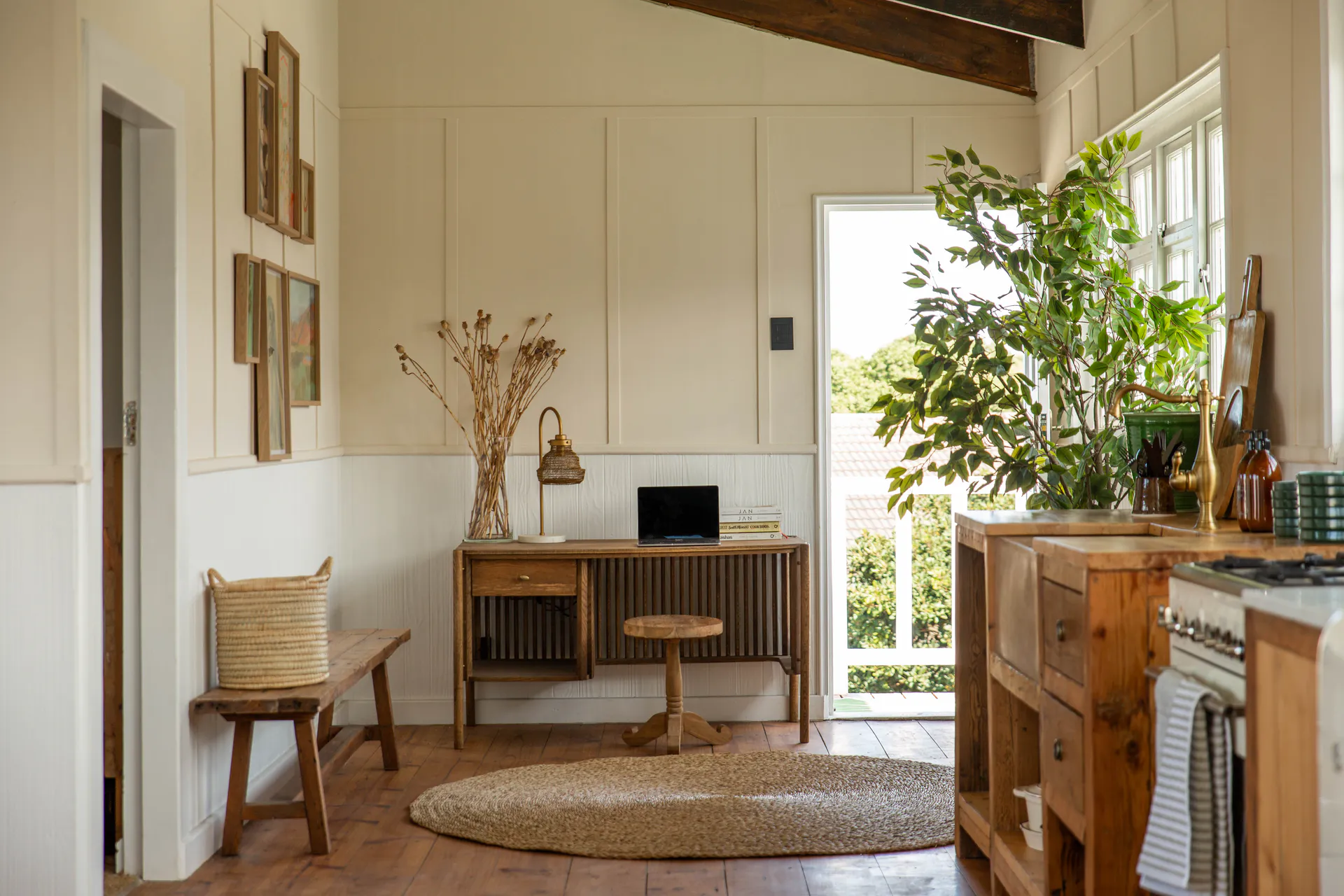 Workspace, kitchen and balcony door in the Sea Facing Apartment