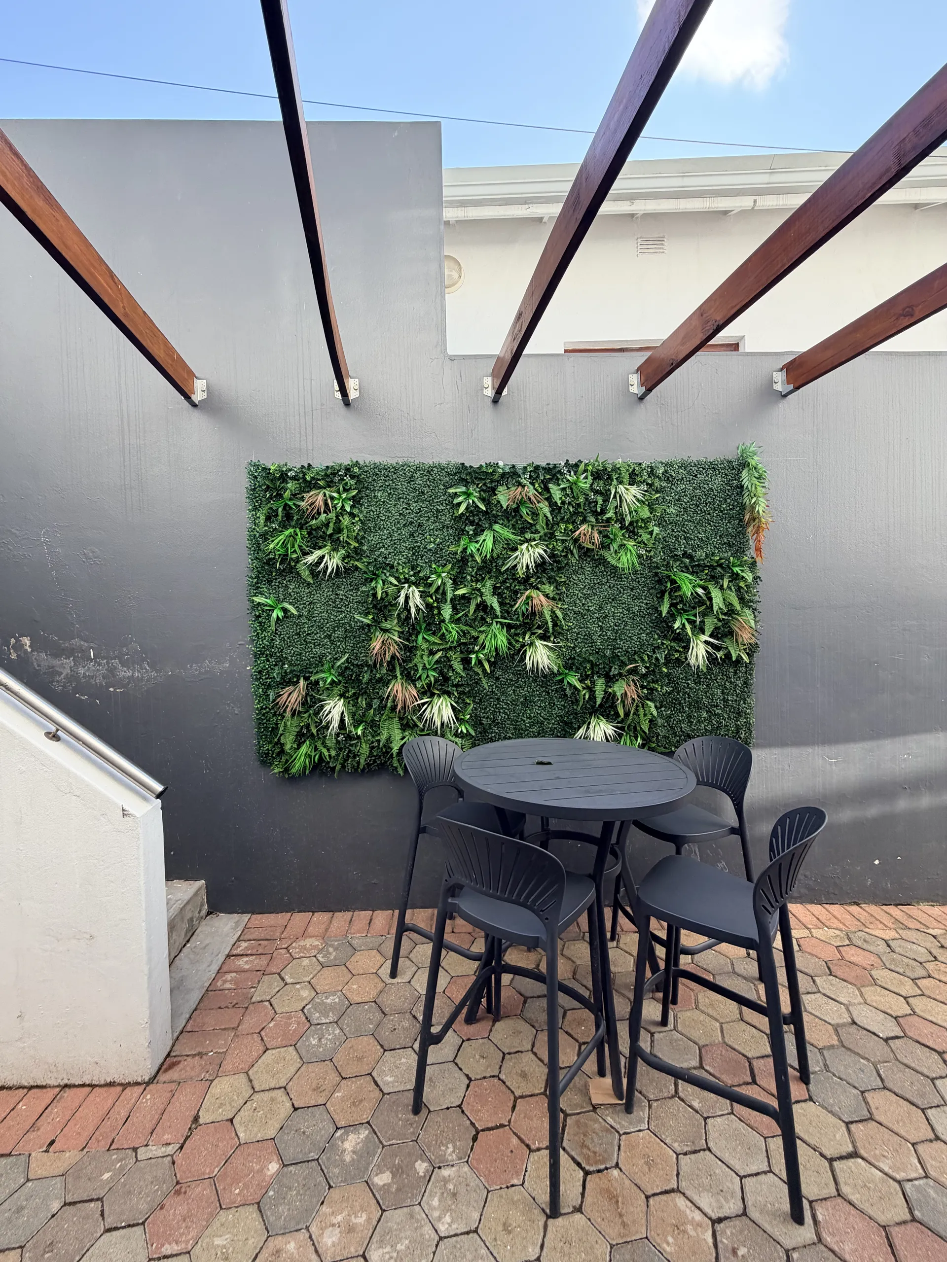 Courtyard dining table against a vertical garden wall