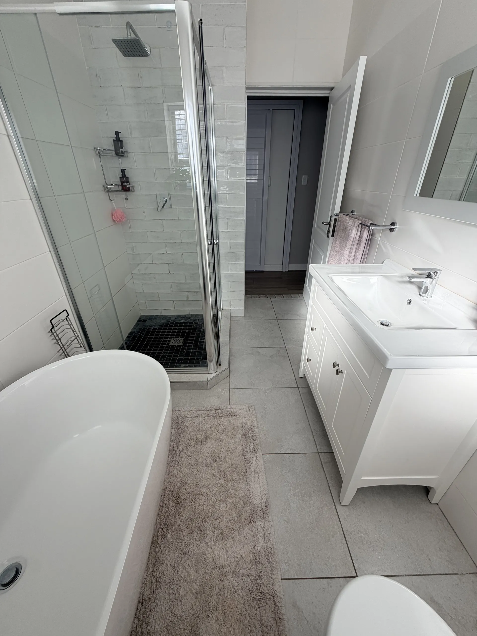 Walk-in shower and vanity in the main bathroom