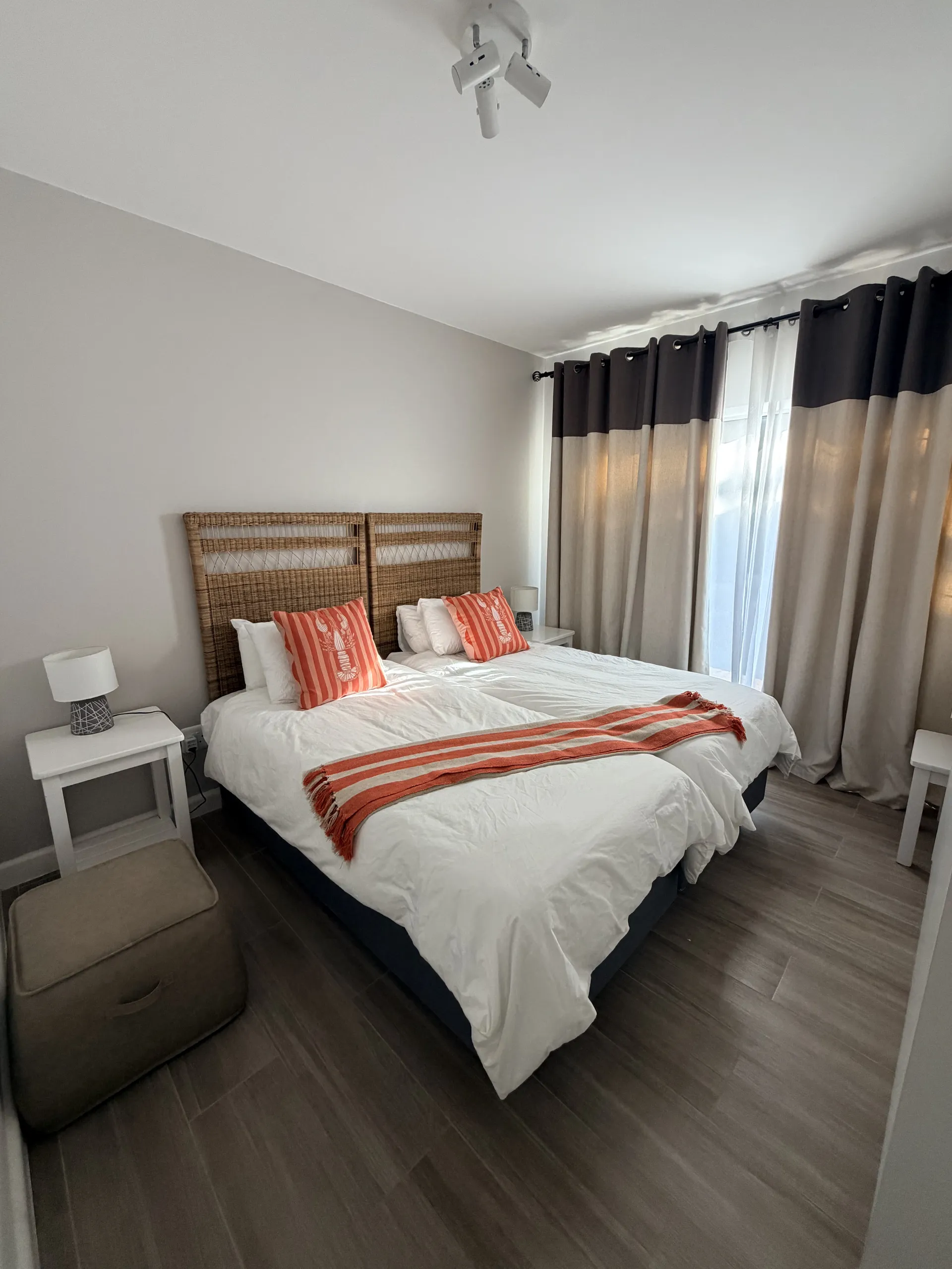 Twin bedroom dressed with orange lobster cushions