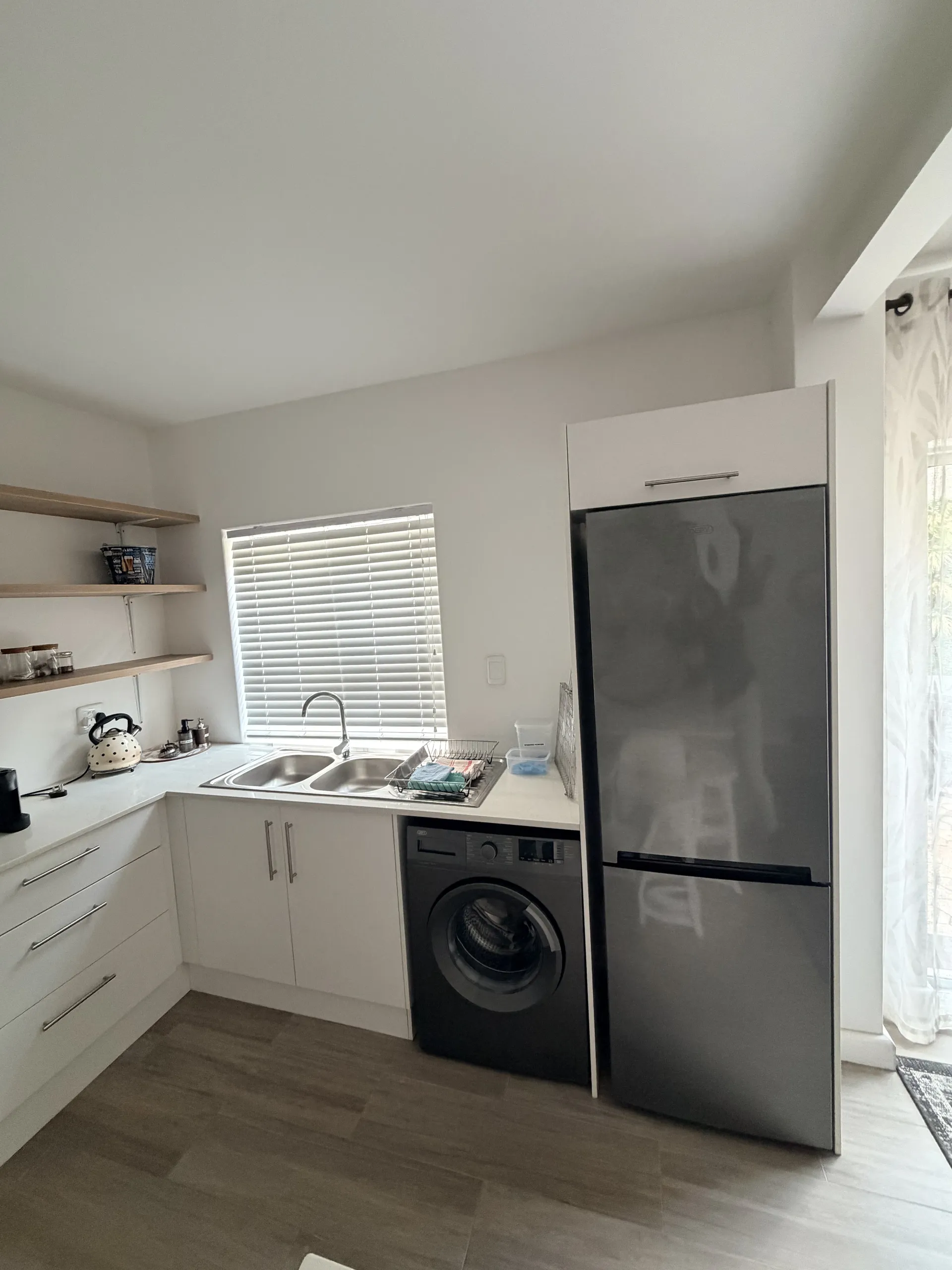 Kitchen sink, laundry machine and fridge