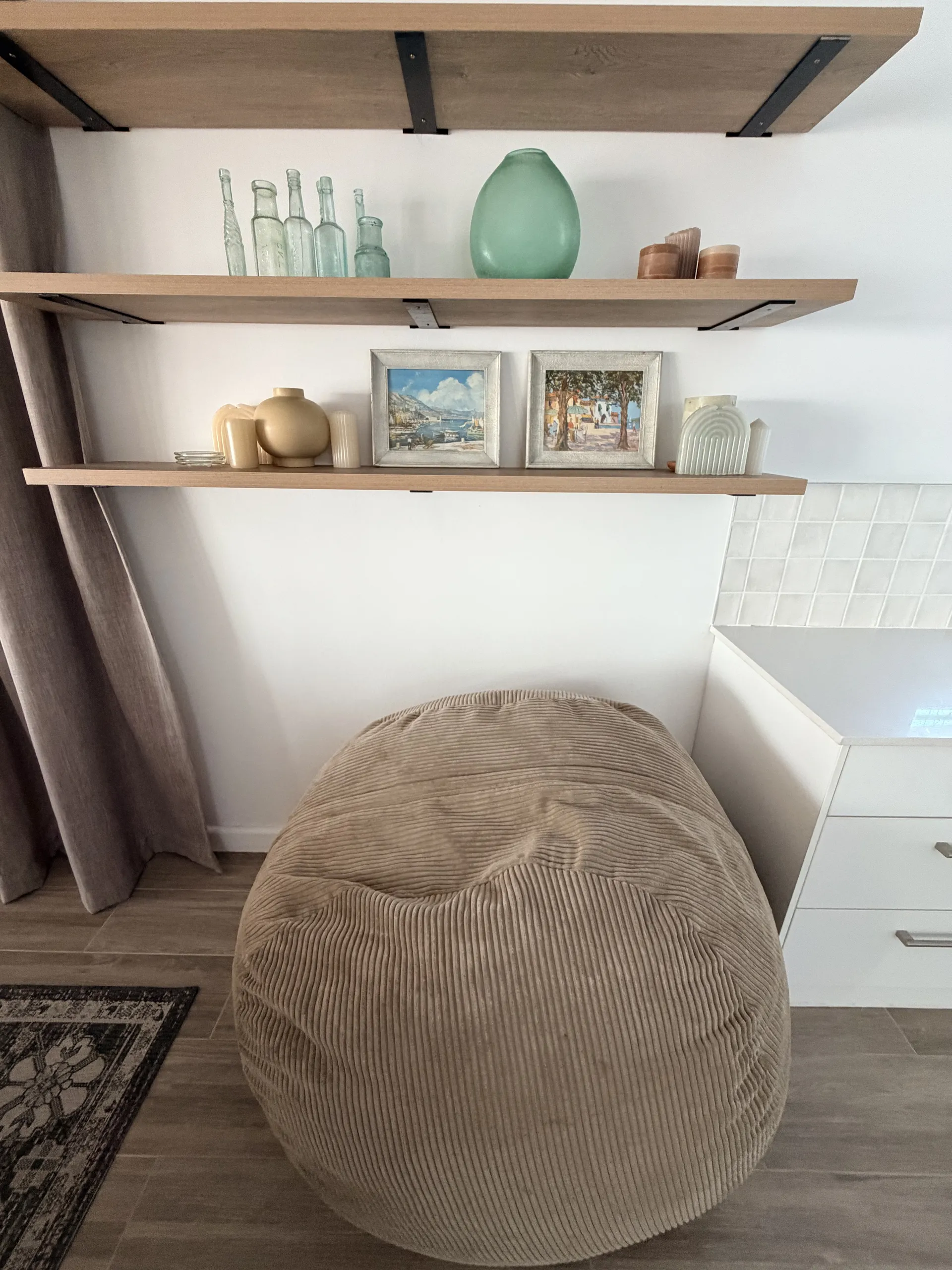 Reading corner with a bean bag and coastal bottle display